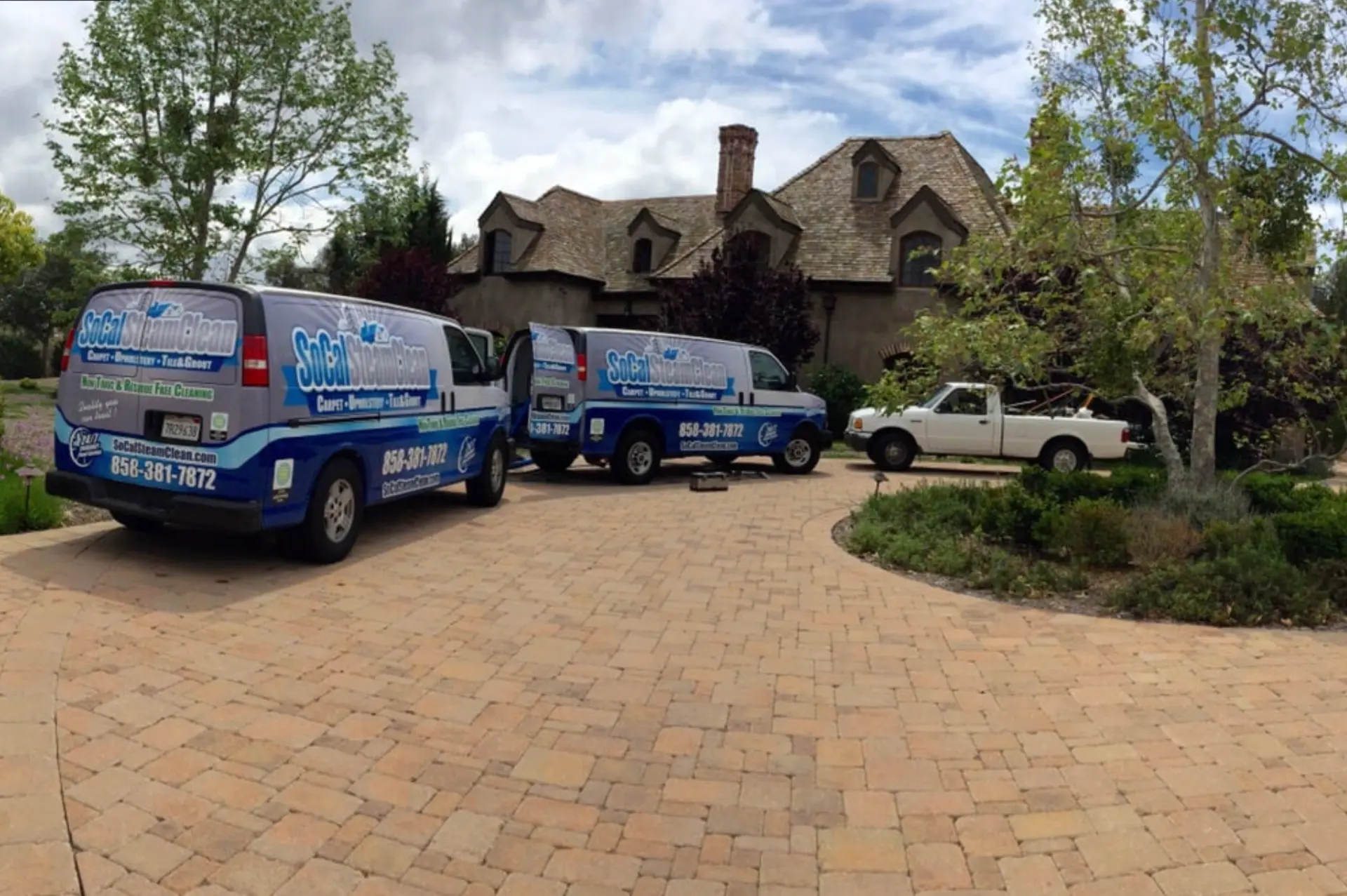 Our fleet in North County San Diego — SoCal Steam Clean Two SoCal Steam Clean vans parked at a large San Diego County estate for a carpet cleaning appointment